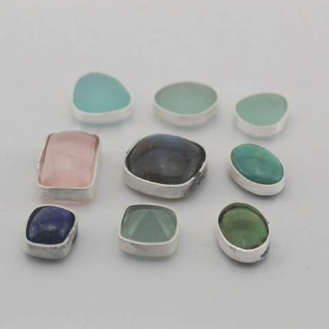 On the bench, waiting for their settings to appear, English sea glass, rose quartz, labradorite, turquoise, lapis and aquamarine - CRT Jewelry